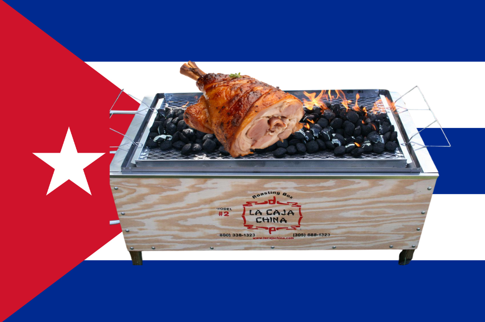 Whole Cuban lechón roasting inside a caja china box during a Miami Nochebuena celebration.